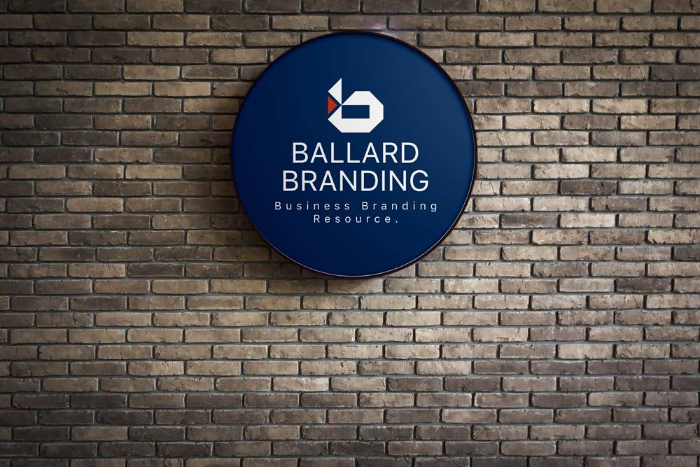 ballard branding sign on brick wall